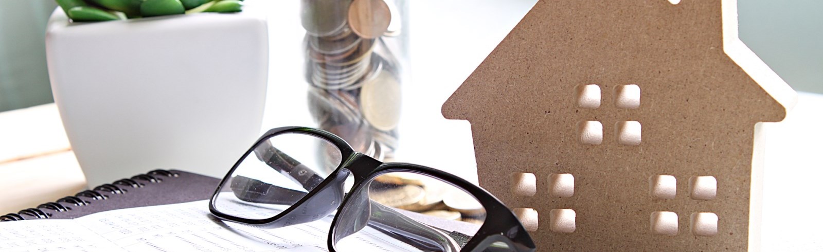 wood house model coins and eyeglasses