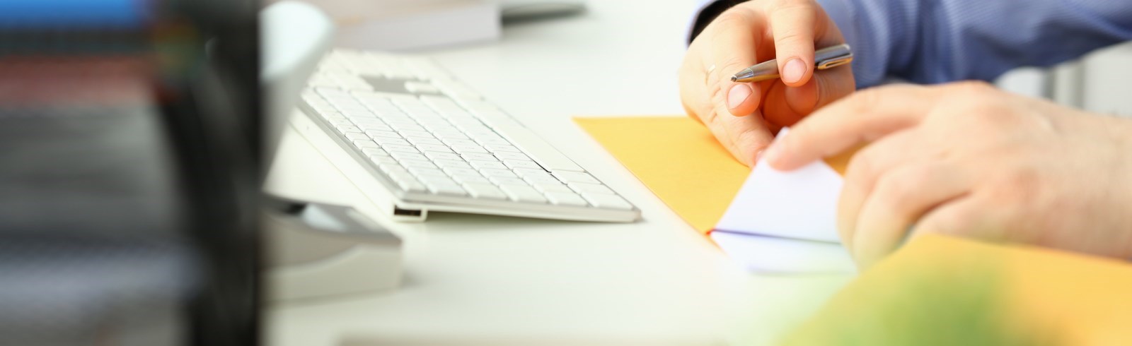 Person sitting at a desk looking at receipts