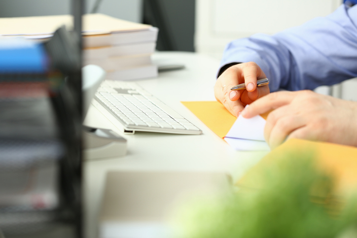 Person sitting at a table holding a receipt