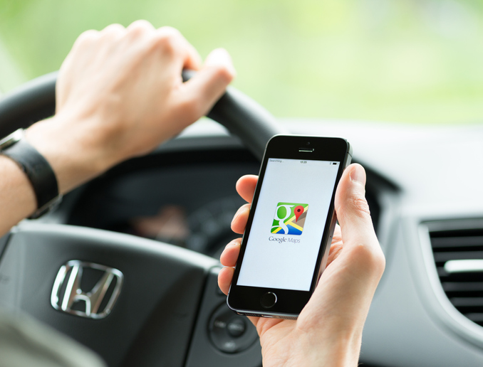 Person holding a phone in a car