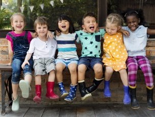 Children laughing on a bench
