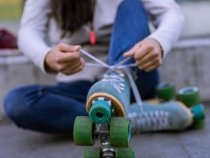 Person tying a roller skate